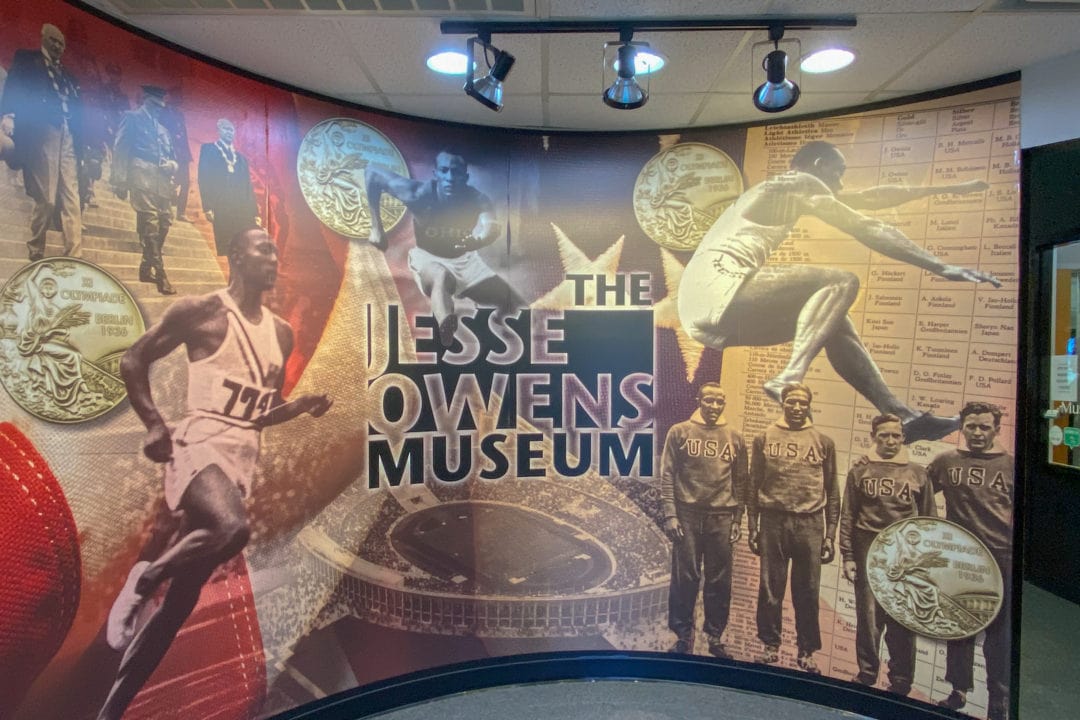 a display at the jesse owens museum featuring photos of the track star
