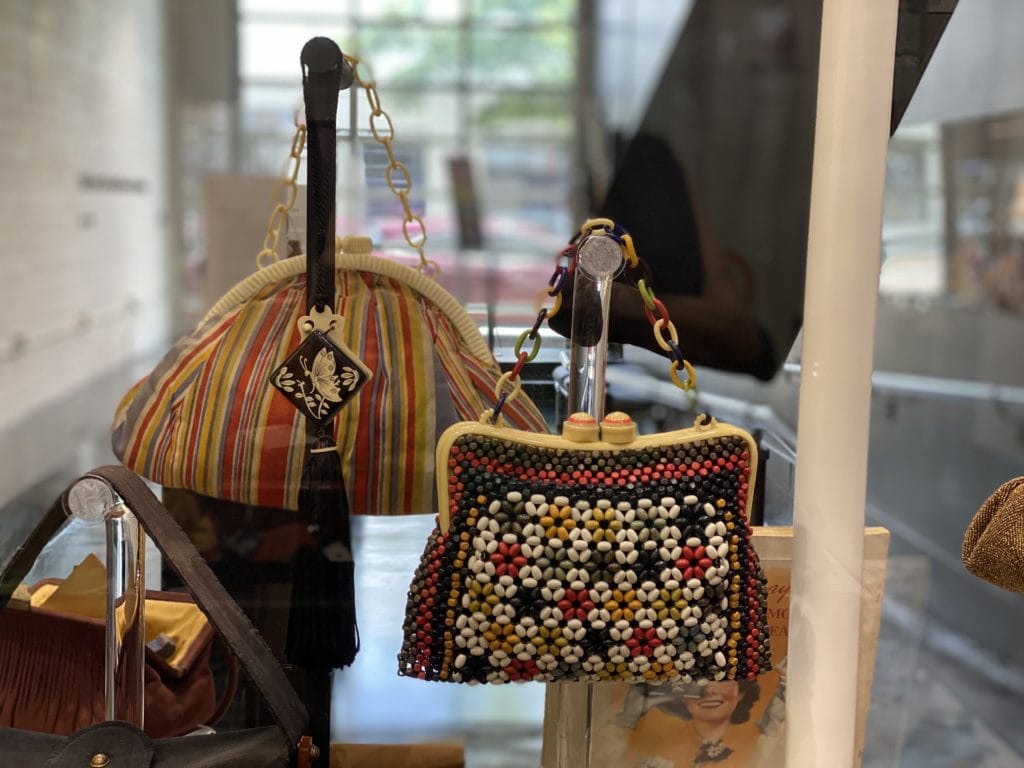 a beaded purse and a striped purse on display at the museum