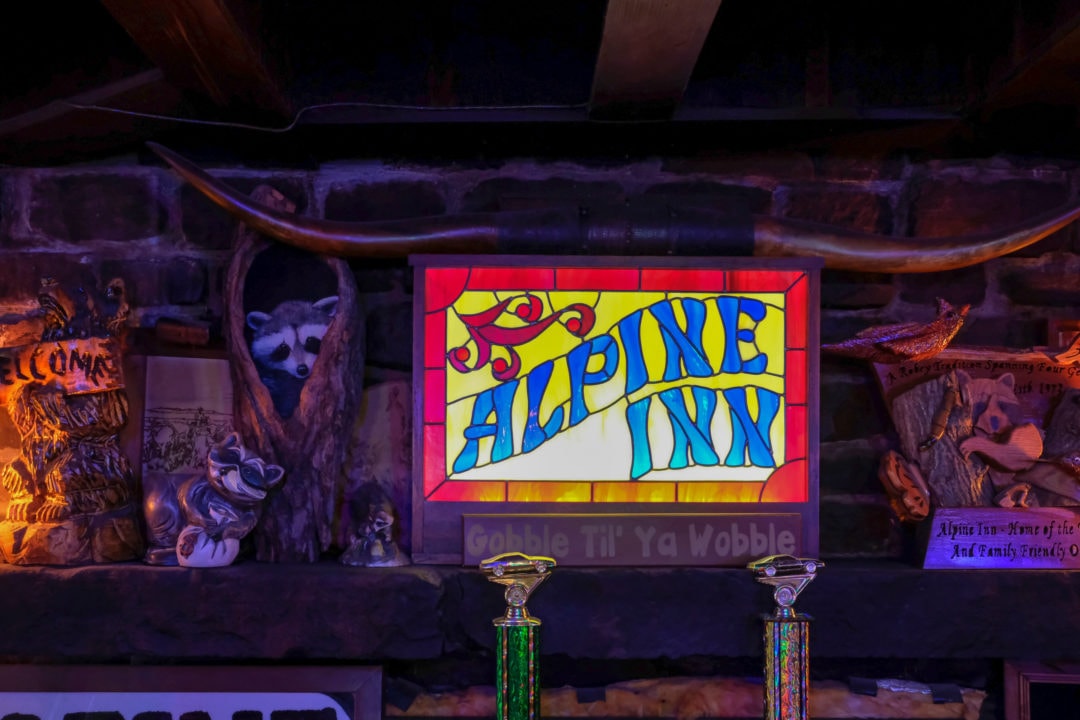 Raccoon items and a stained glass sign that says "alpine inn"
