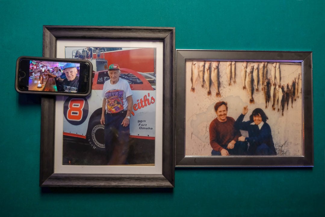 Framed photographs of Glenn and Flav Robey on a turquoise wall