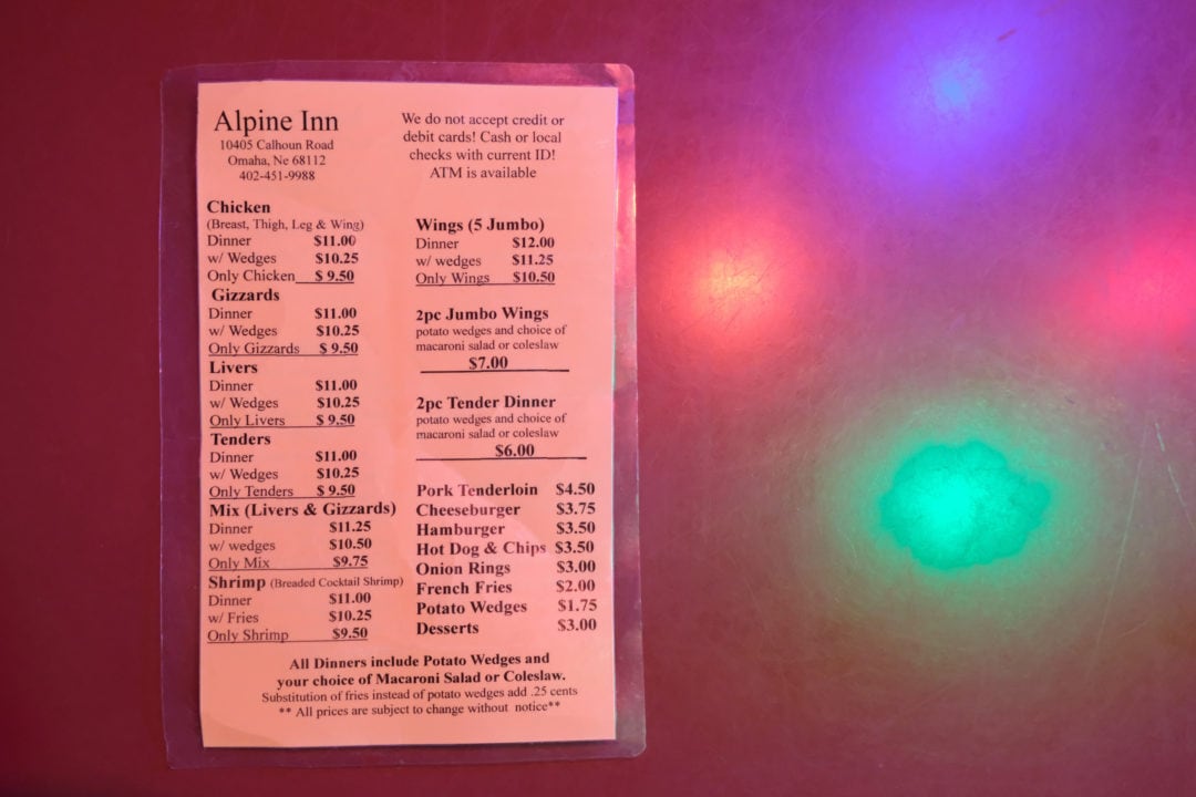 A black and white laminated menu for the alpine inn restaurant