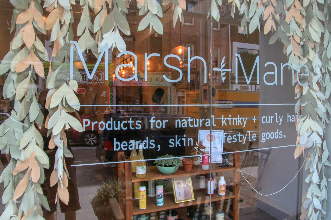 marsh + mane's front window display features greenery