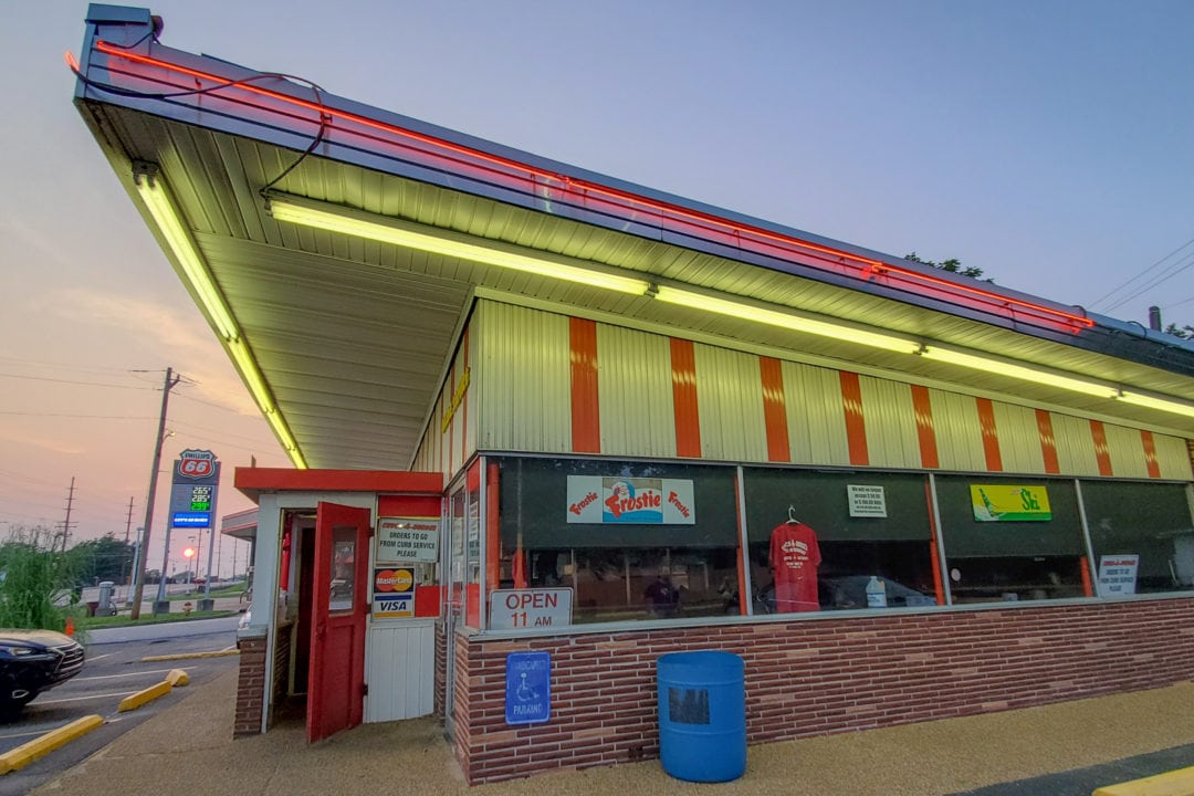 a sloping roof and red-and-white striped exterior of chuck-a-burger