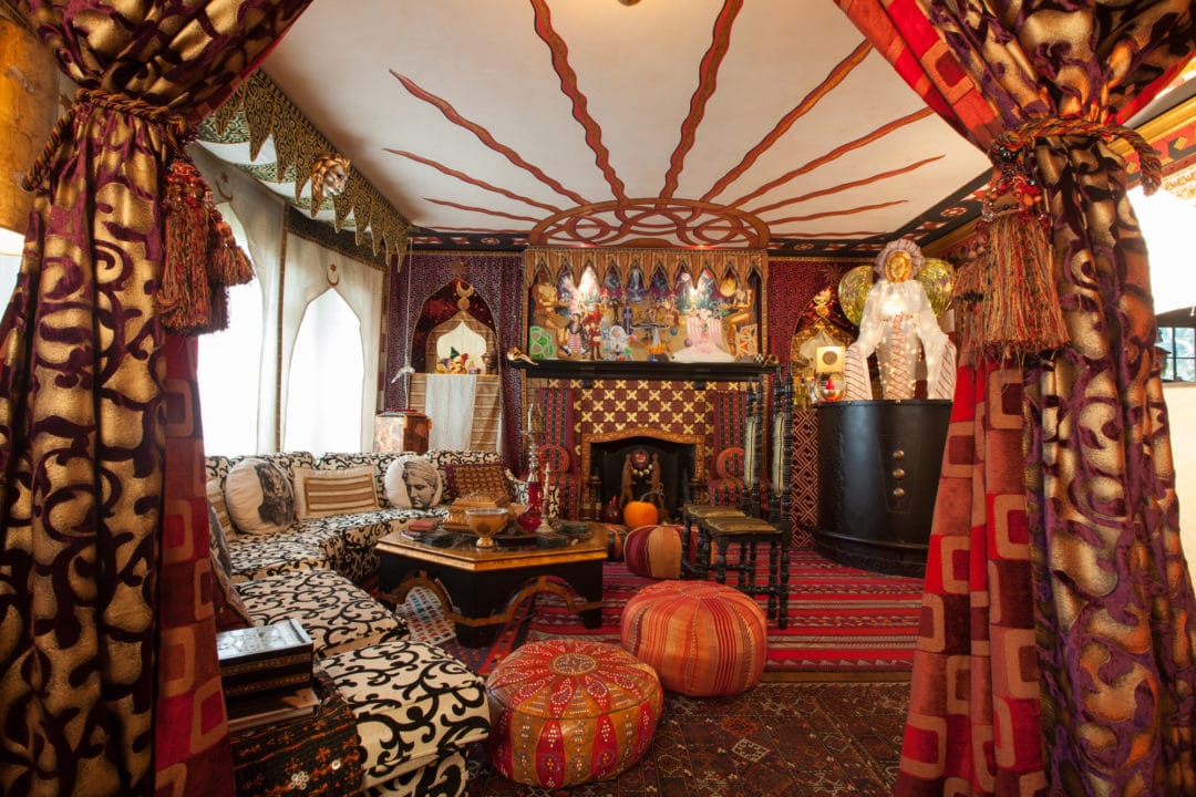 A room decorated in brown and red fabrics