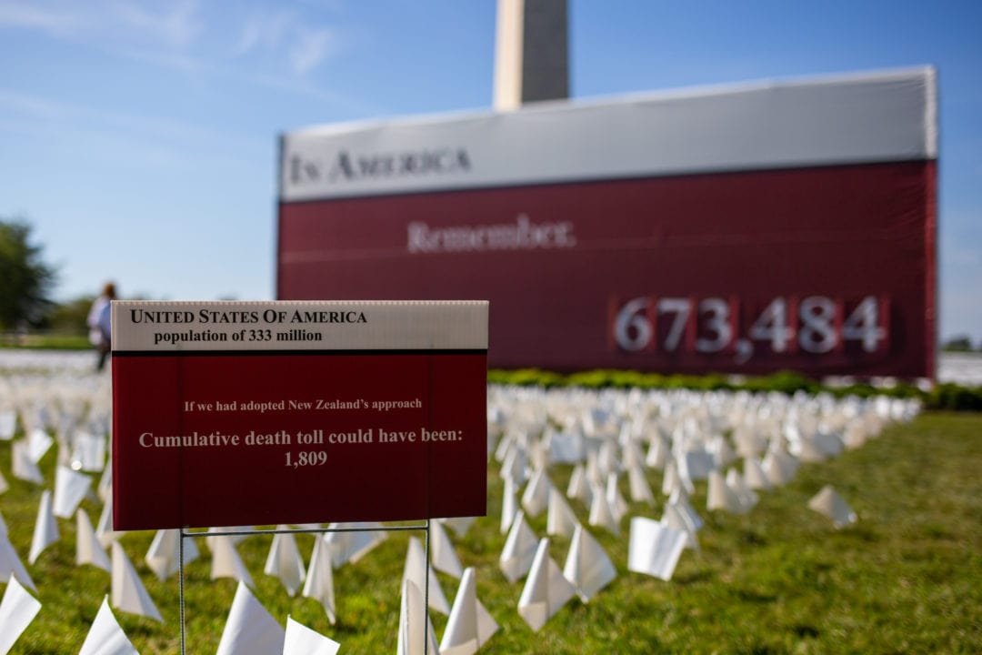 an informational sign reads "if we had adopted new zealand's approach the cumulative death toll could have been 1,809"
