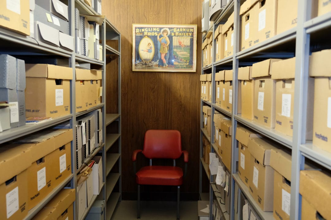 boxes in a research library with a red chair