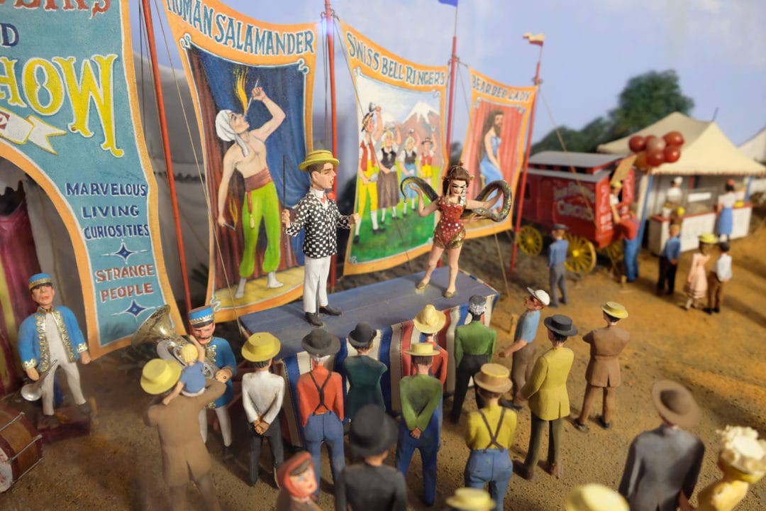 a miniature model of a circus theme featuring a snake charmer