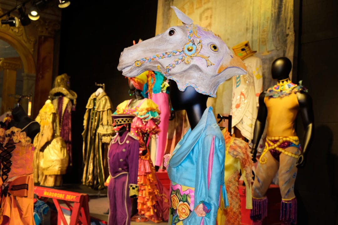 colorful circus costumes including a two-headed mask