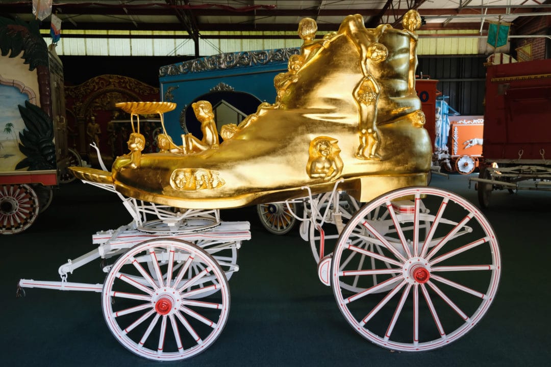 a gold circus wagon shaped like a shoe