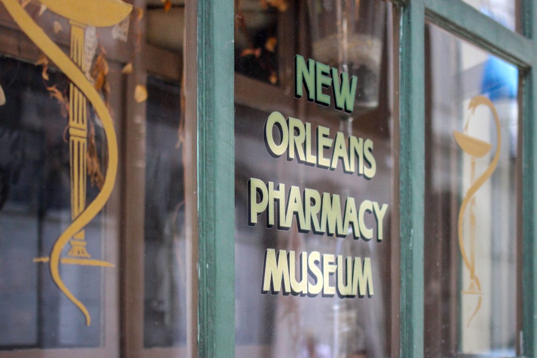 window that says "new orleans pharmacy museum"