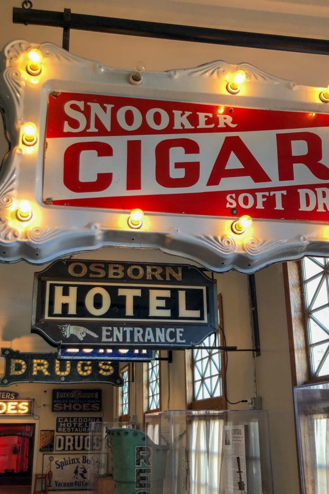 antique signs hanging in a museum
