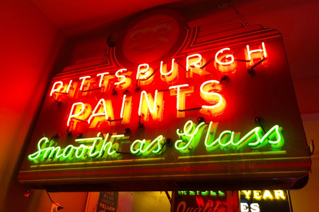 a neon sign that says "pittsburgh paints smooth as glass"
