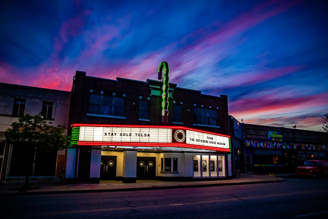 Historic theatre with neon sign at dusk