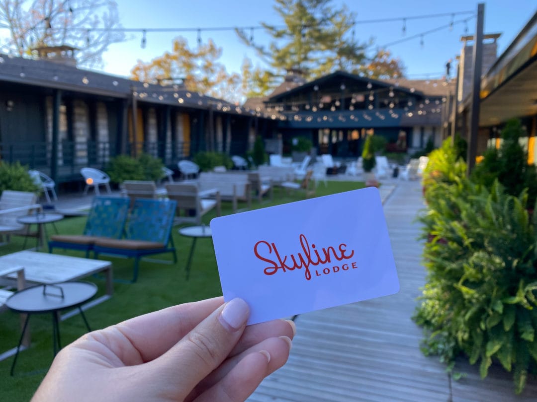 Hotel keycard "Skyline Lodge" held up in front of courtyard entrance