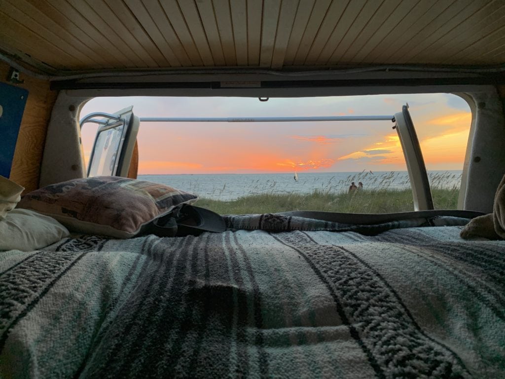 View from back of van at sunset on beach