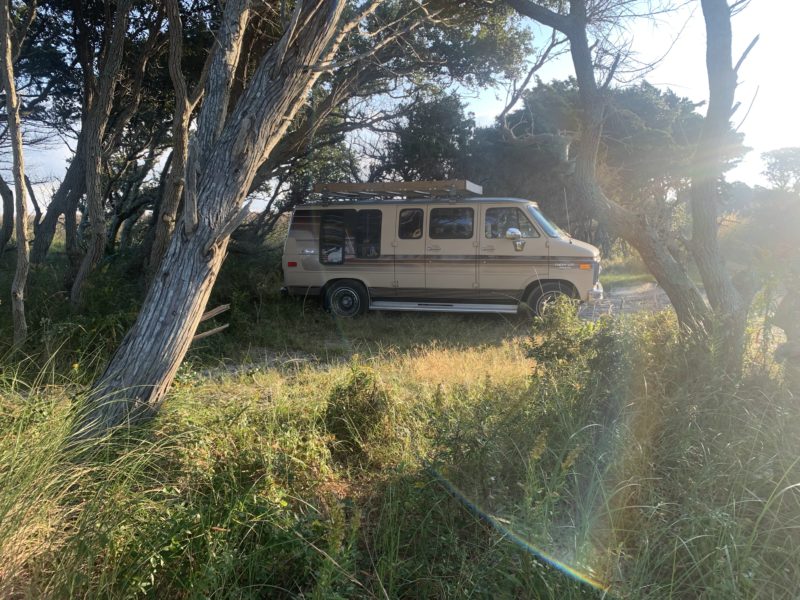 Van parked in boondocking site near beach
