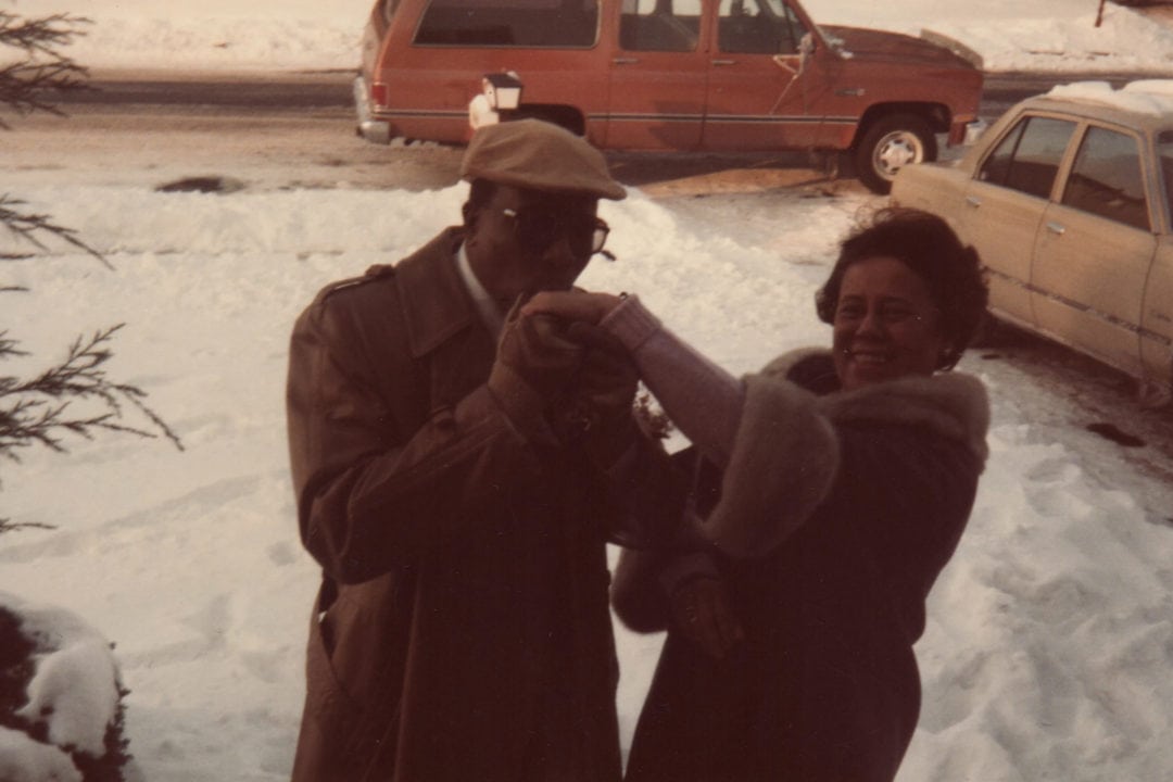 a man kisses a woman's hand in the snow