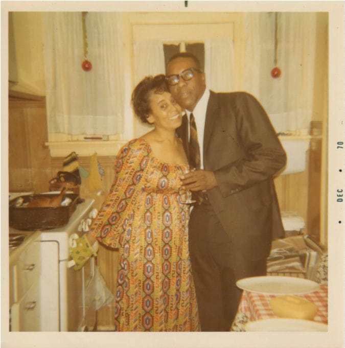 a couple are dressed up in a kitchen
