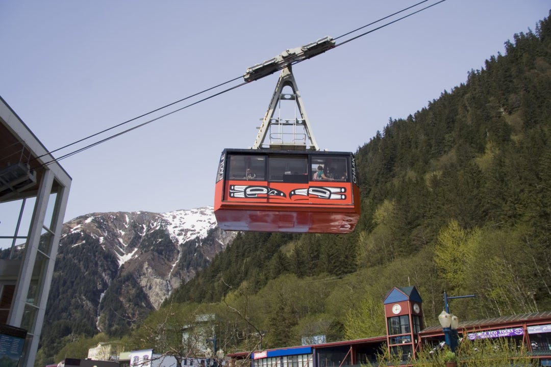 a red tram travels up a mountain