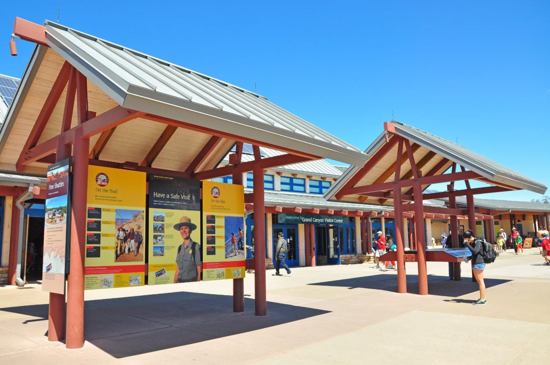 the entrance to the grand canyon visitor center under blue skies