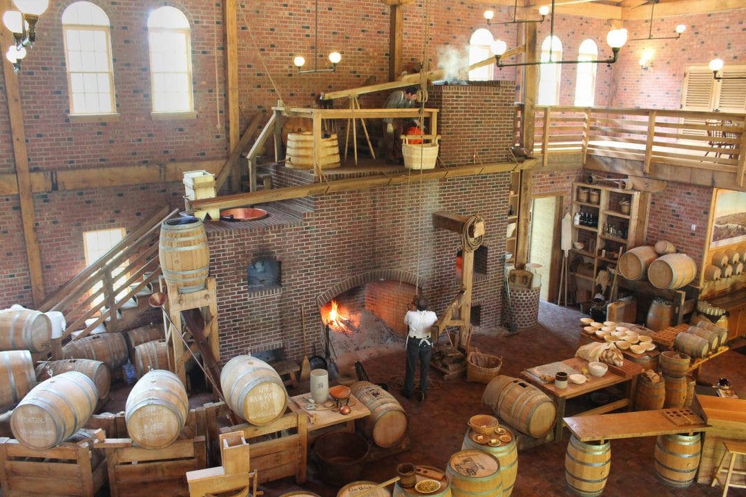 Brick walled warehouse with large fireplace and barrels for beer production