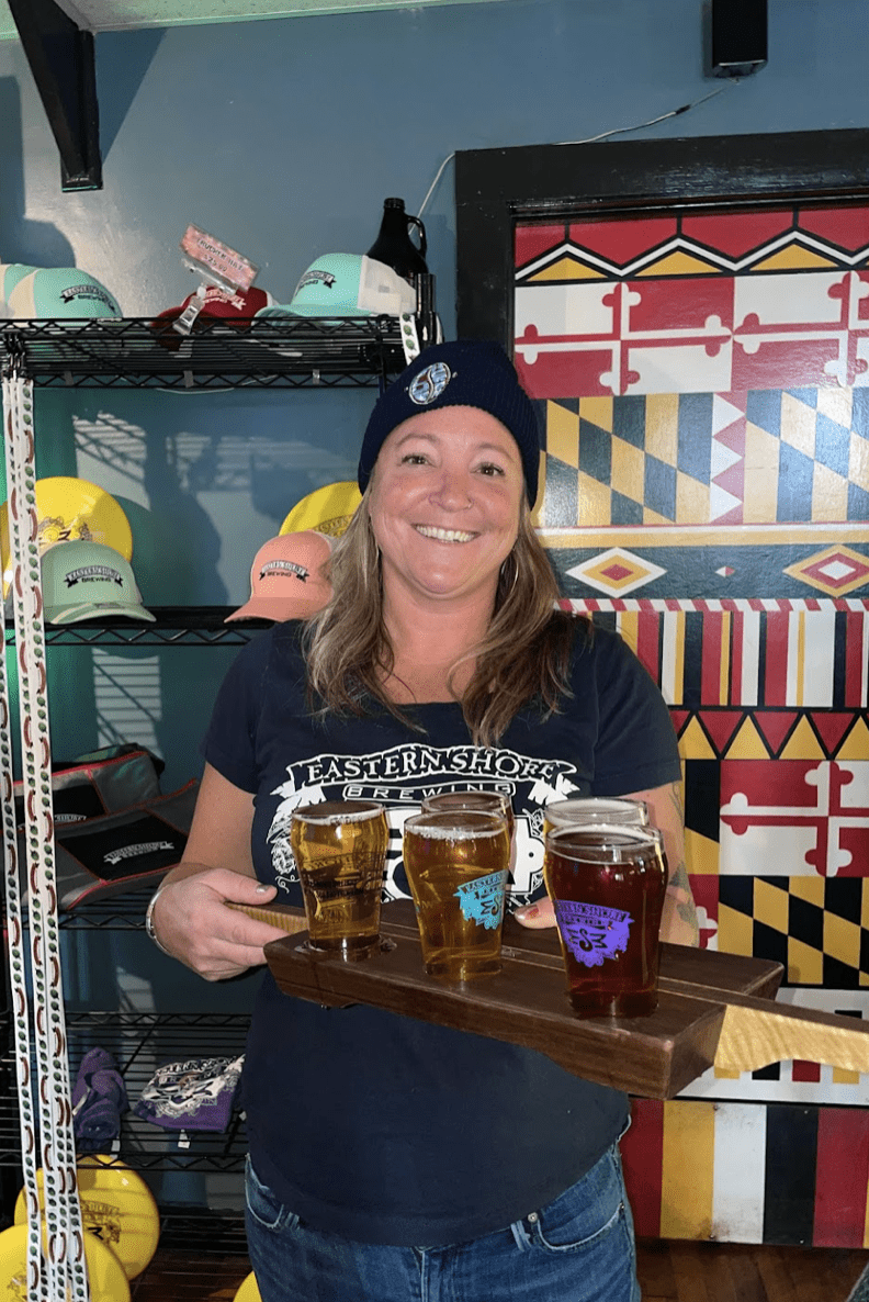 Woman holding a beer flight in Maryland.