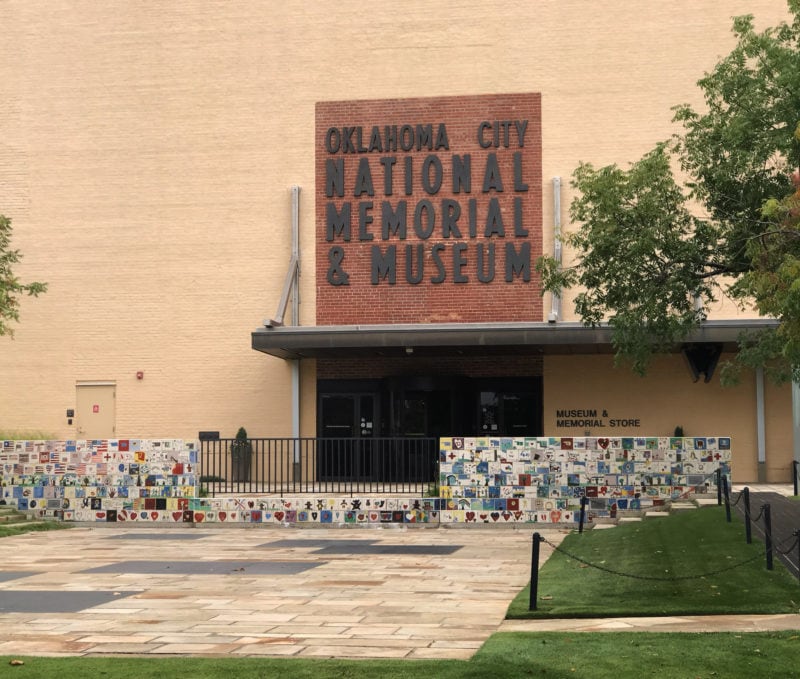 the entrance to the oklahoma city national memorial museum, housed in a beige brick building