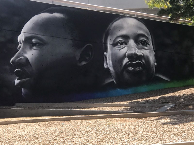 a street art mural featuring two black and white portraits of martin luther king jr