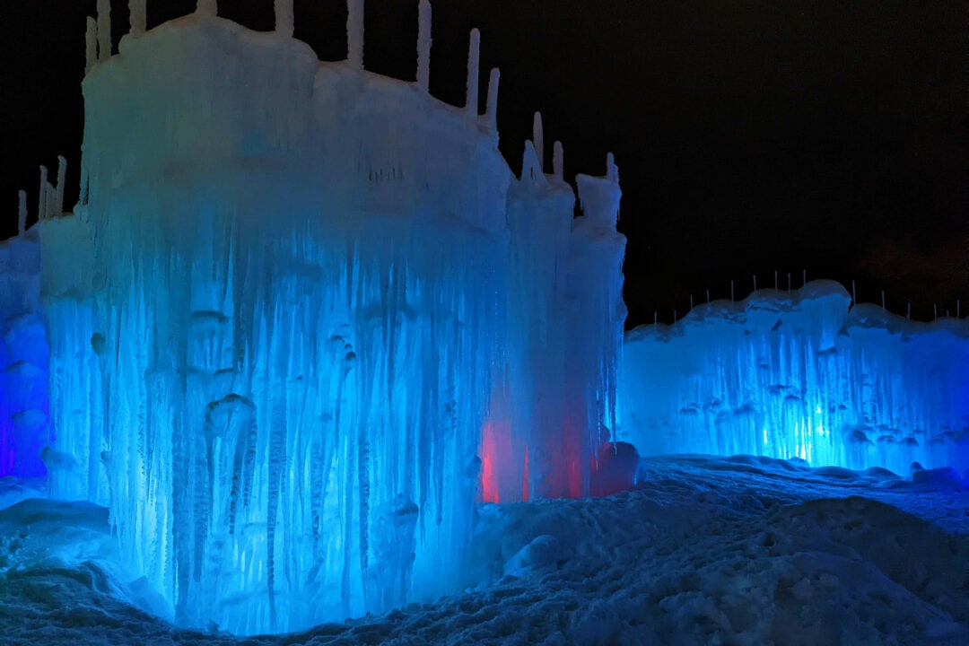 an ice castle lit up blue at night