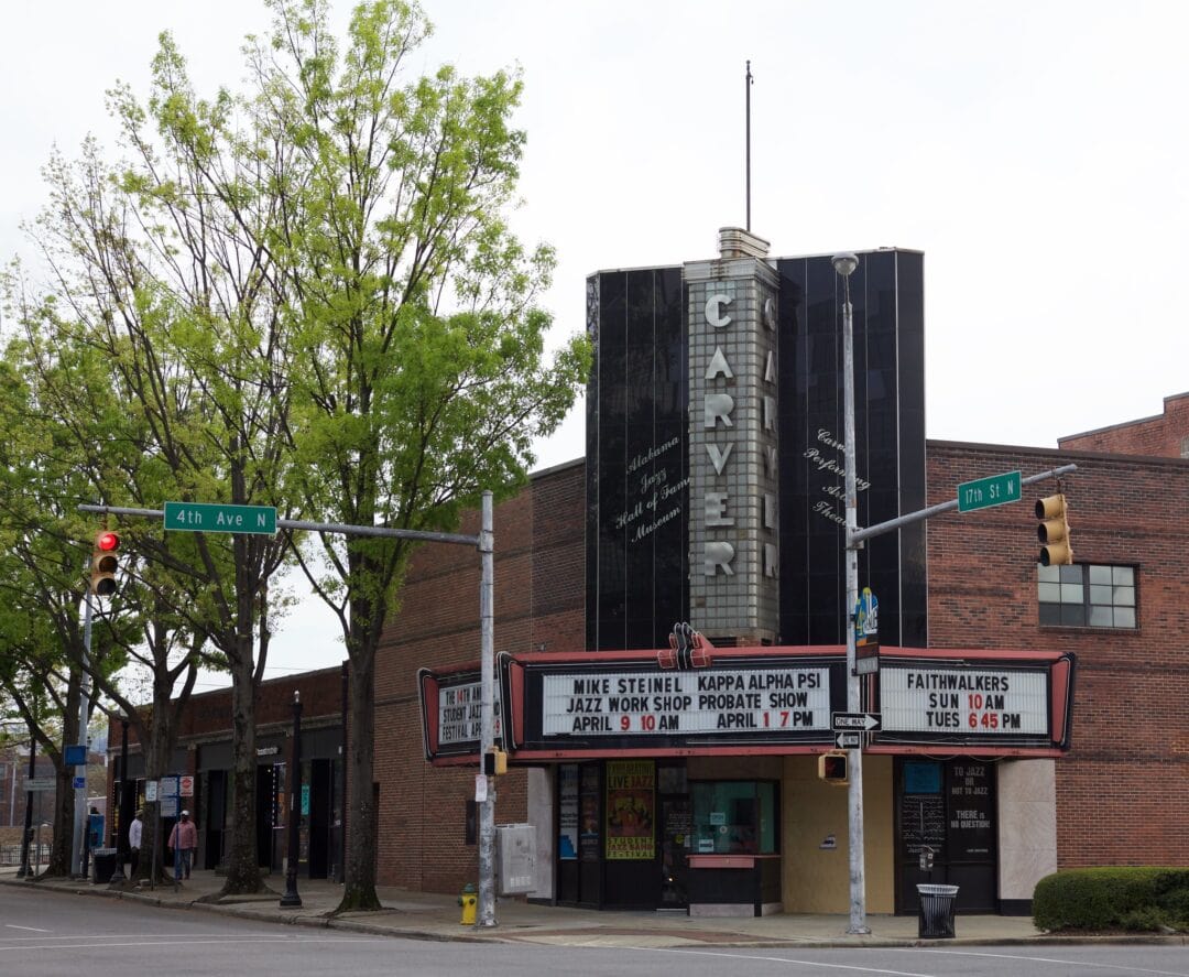 an art deco theater brick facade with a glass block sign that says Carver and a marquee