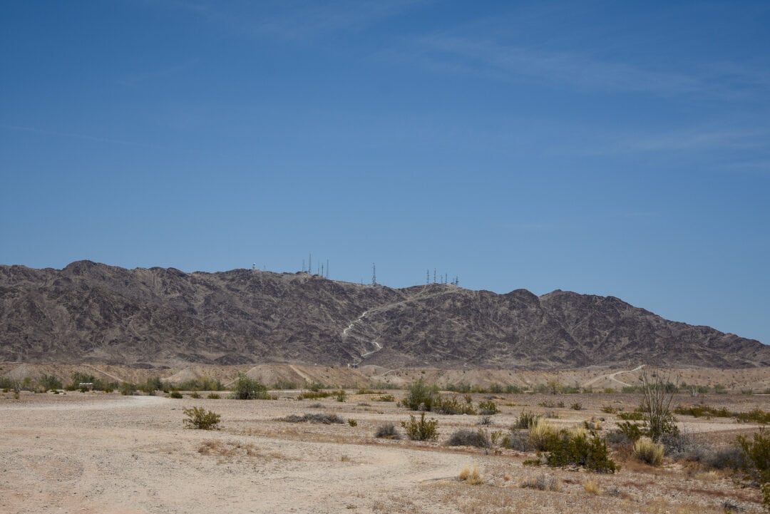 An empty desert view with mountains in the background