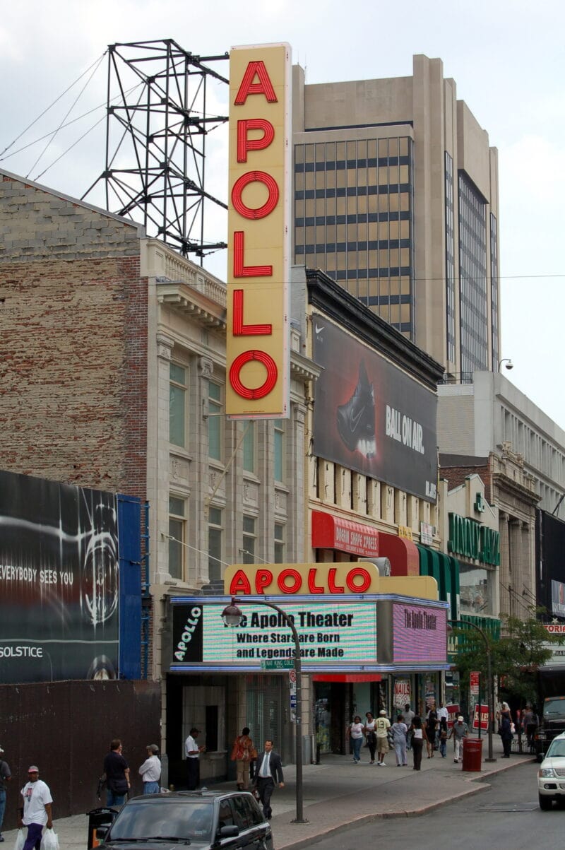 a red and yellow vertical neon sign for the facade of the apollo theater in new york