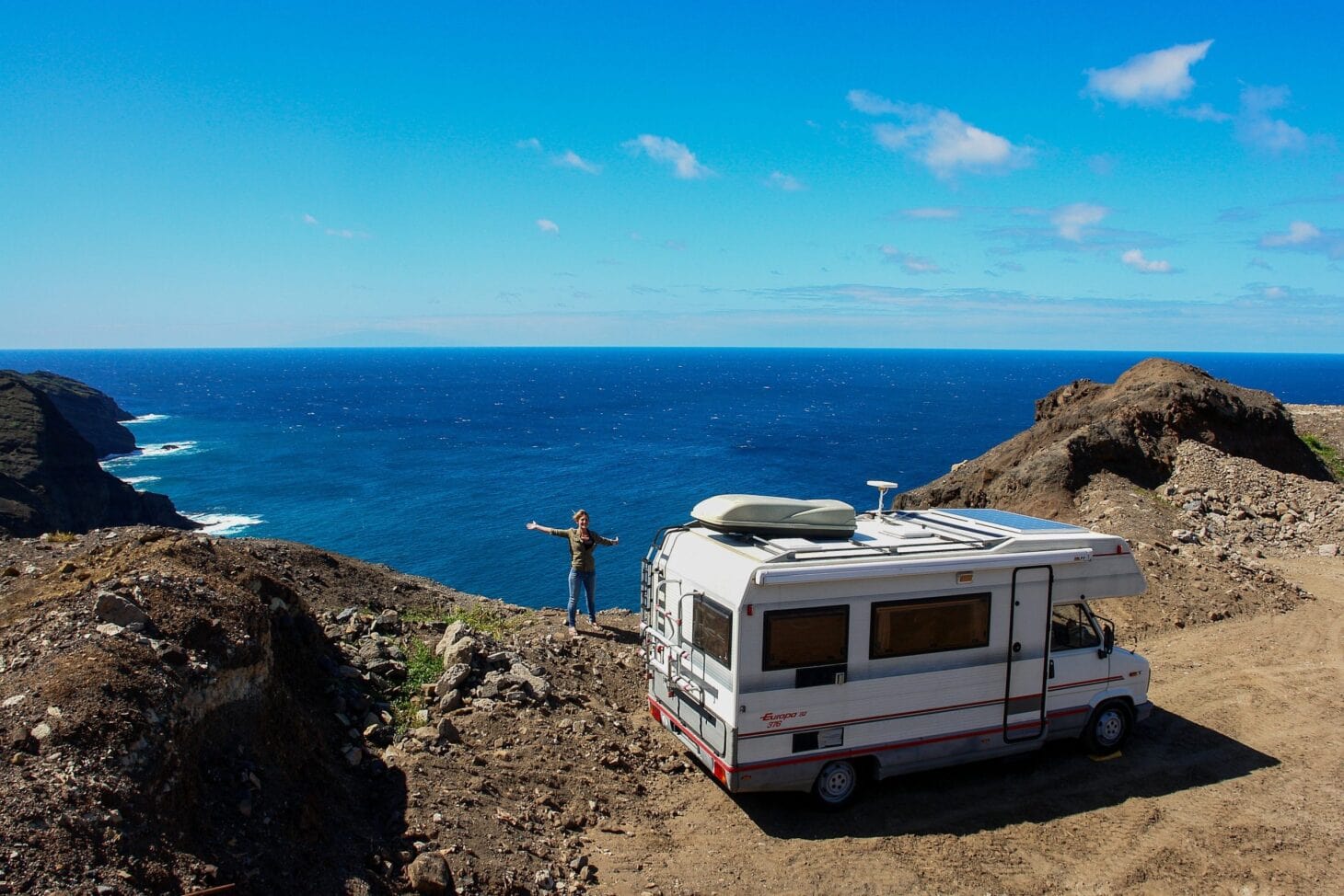 RV parked on a bluff near water