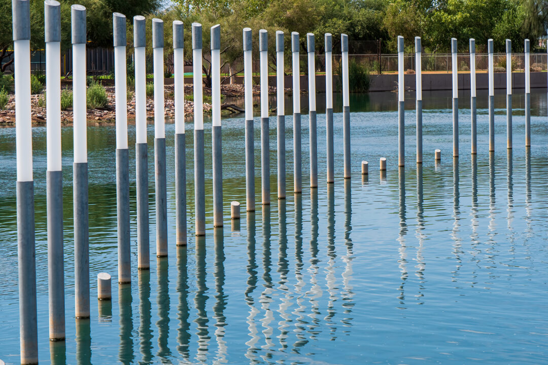 a memorial featuring several markers that rise out of the water