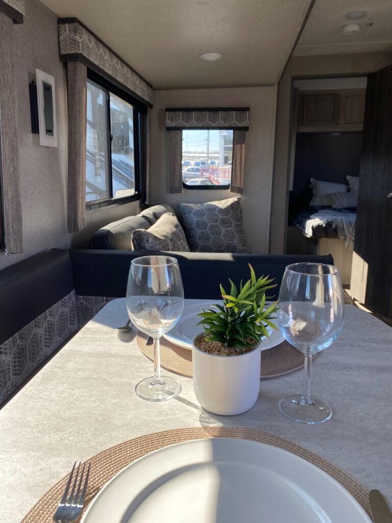 Interior of an RV with a dinette and couch.