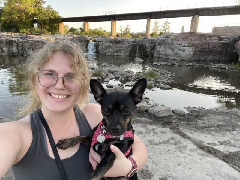 Woman and her dog standing near water in Sioux Falls, South Dakota