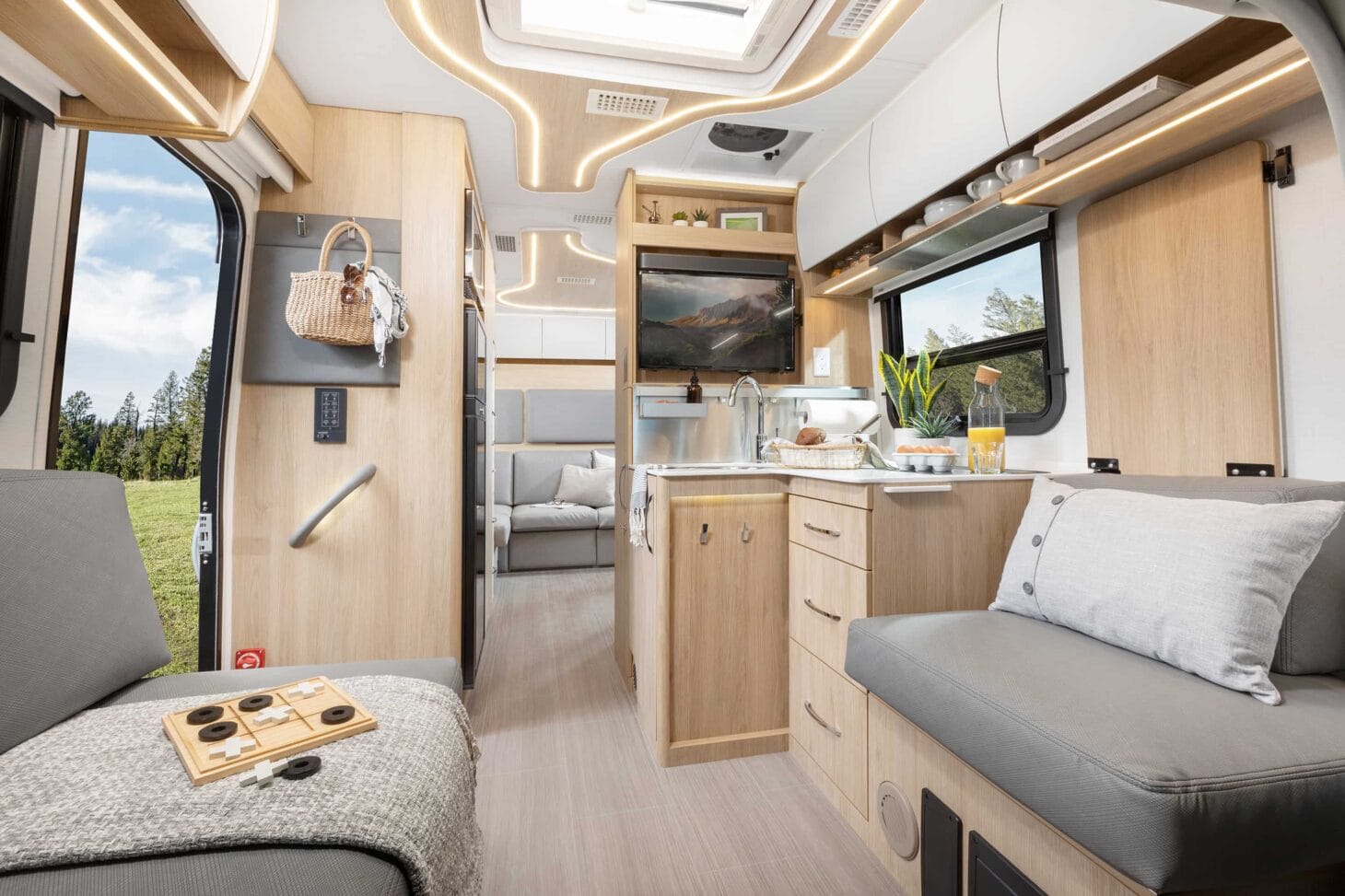 Interior seating and kitchen area of a Class B+ RV