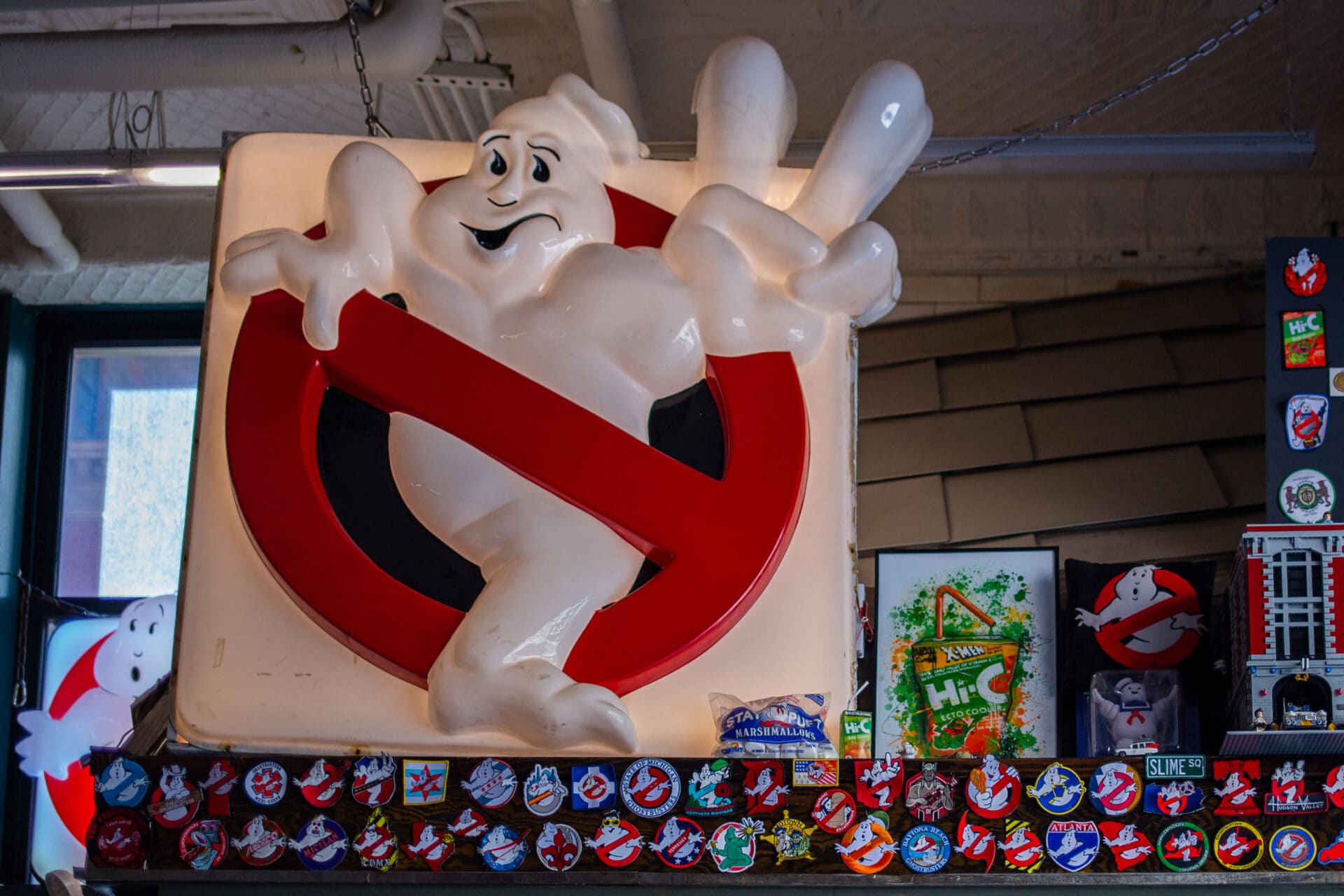a red and white ghostbusters sign and other memorabilia