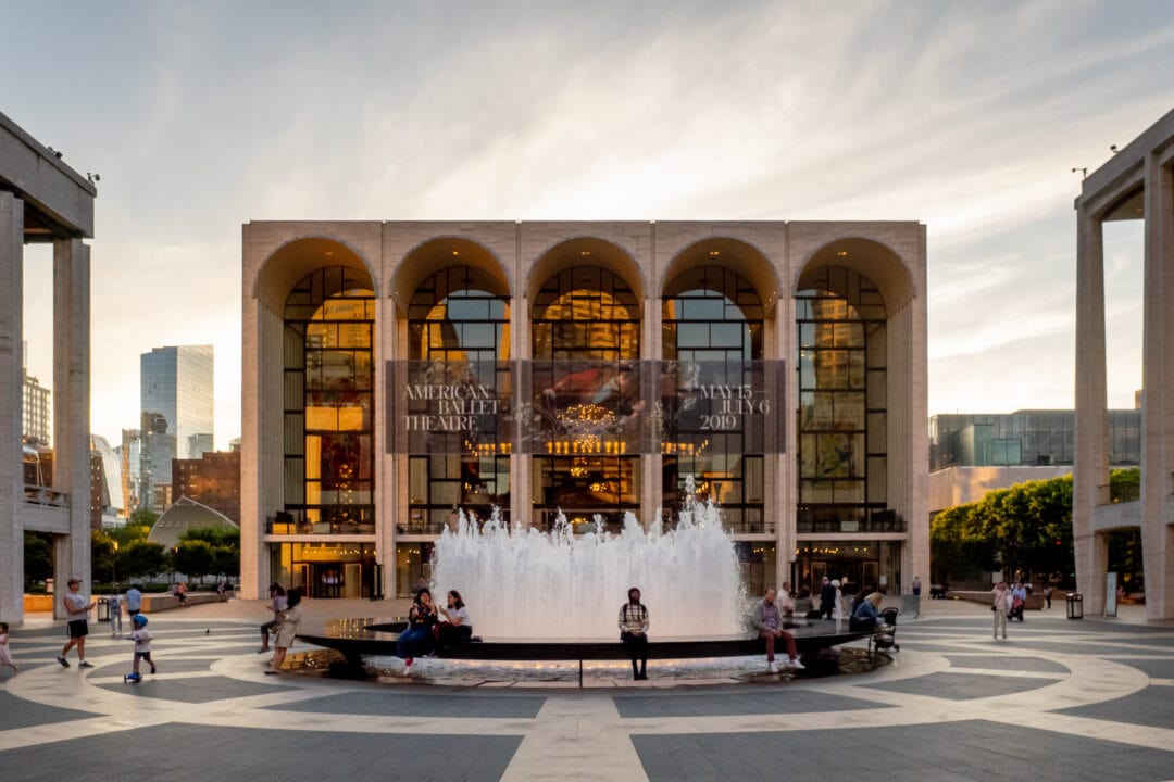 the plaza at lincoln center with the metropolitan opera building and a fountain