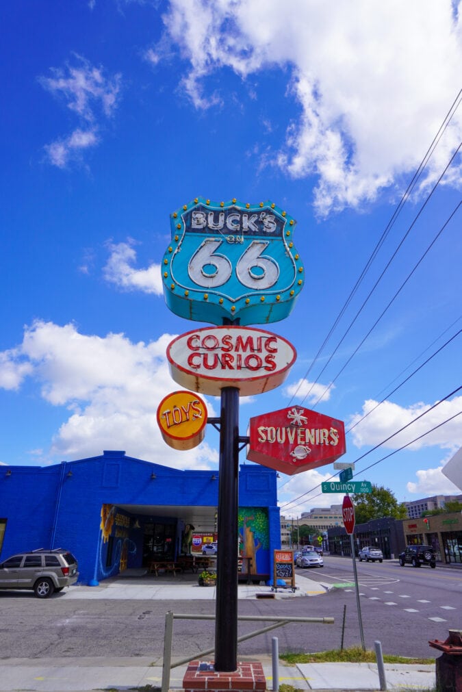 A brightly colored vintage-inspired sign for Buck Atom's Cosmic Curios