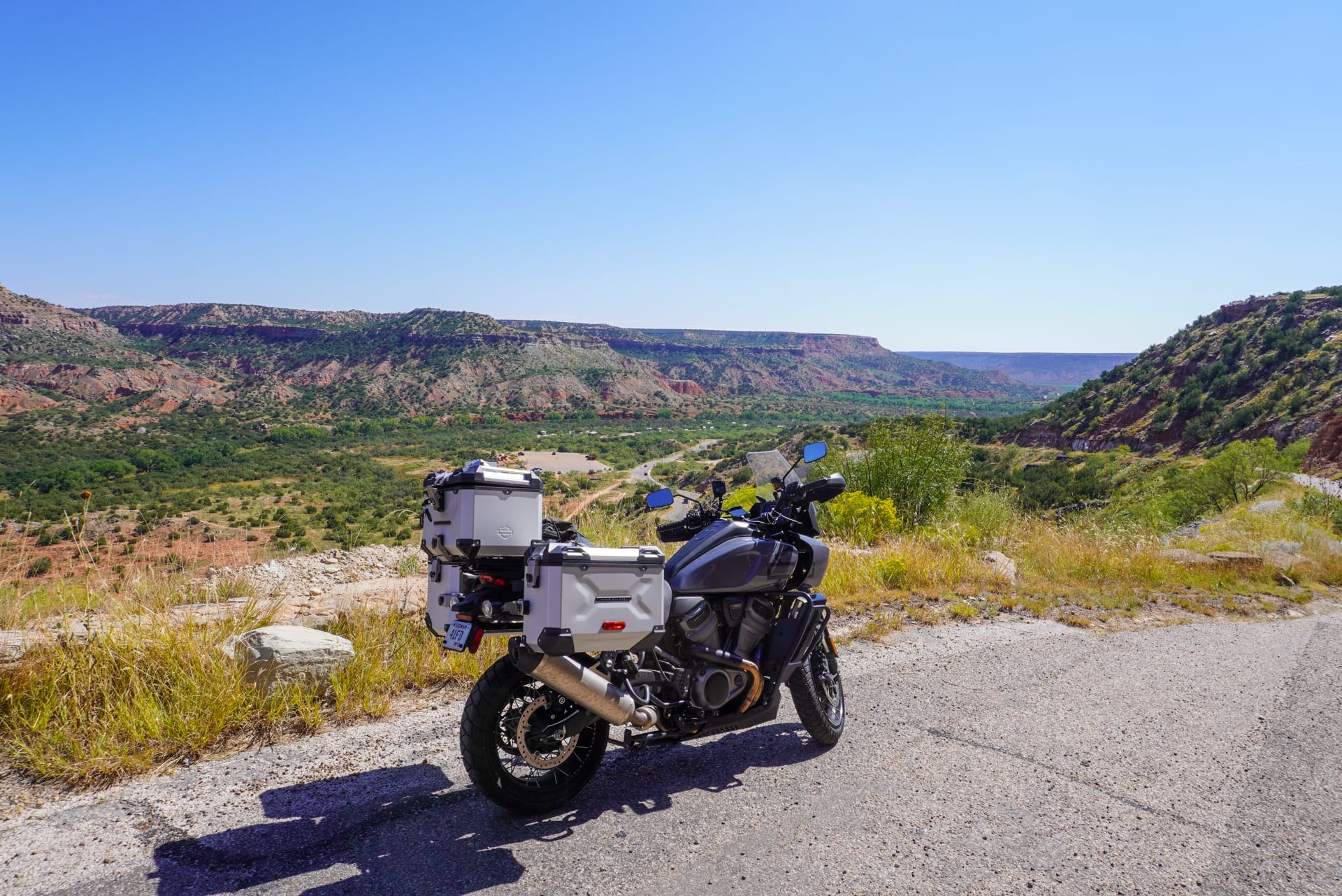 A motorcycle parked at the top of a scenic canyon