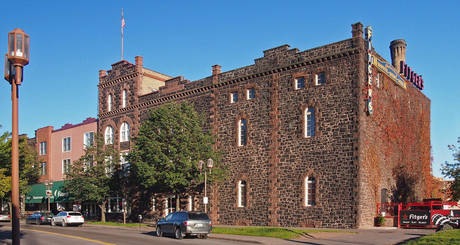 a castle-like red brick building against a blue sky