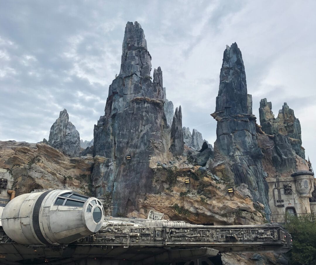 Towering gray rock formations above a sci-fi-inspired aircraft