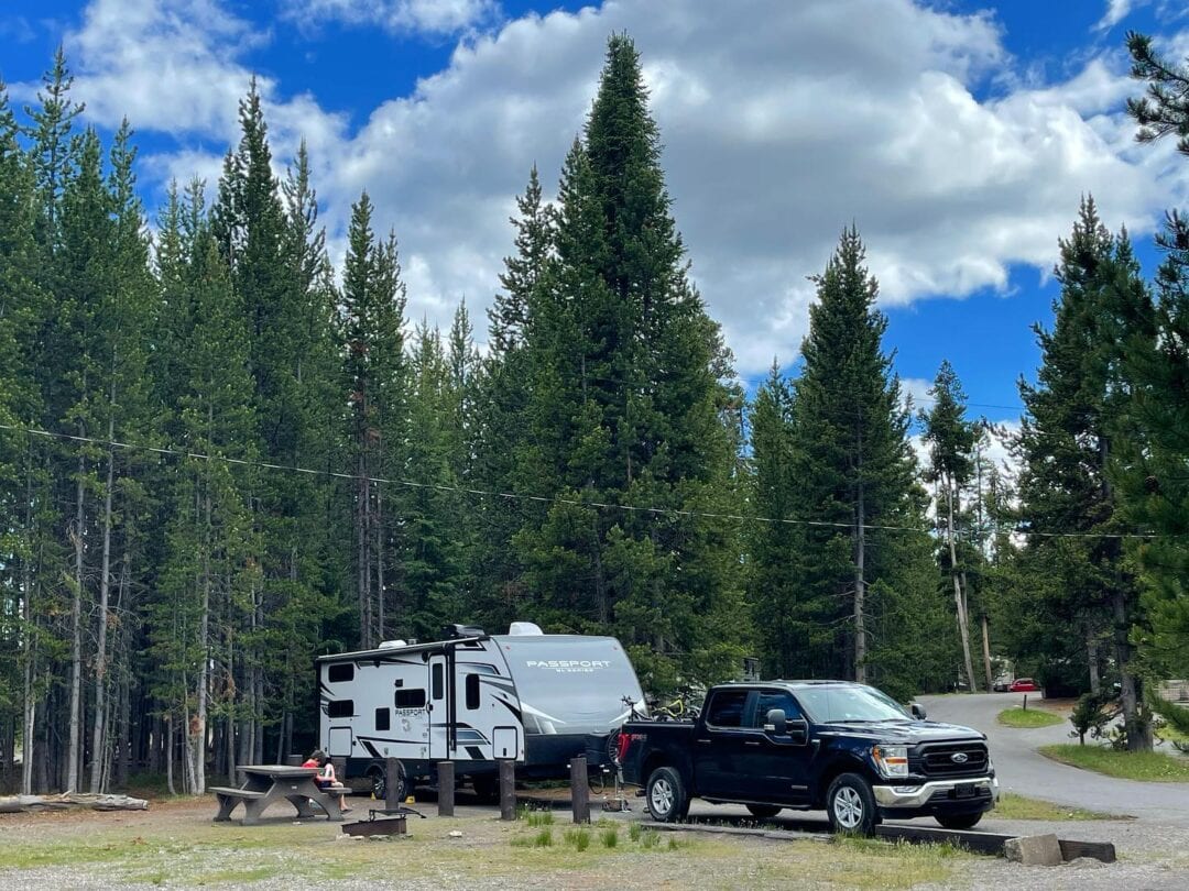 RV parked at a campsite near a wooded area outside of Yellowstone