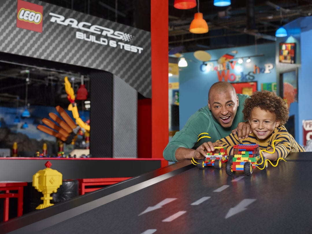Father and son racing LEGO cars at the LEGOLAND Discovery Center