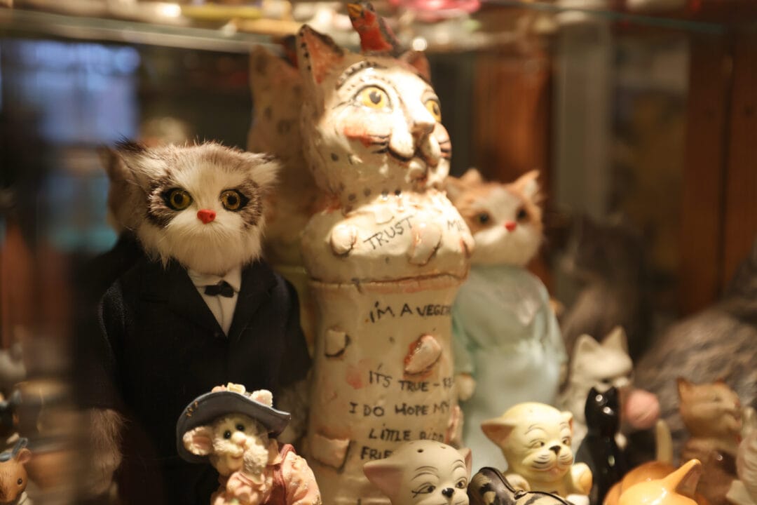a collection of cat figurines on display