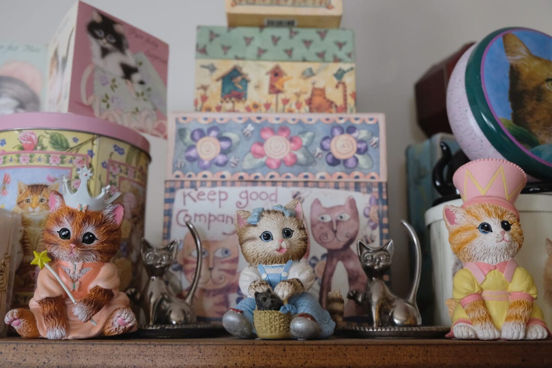 a shelf with cat figurines