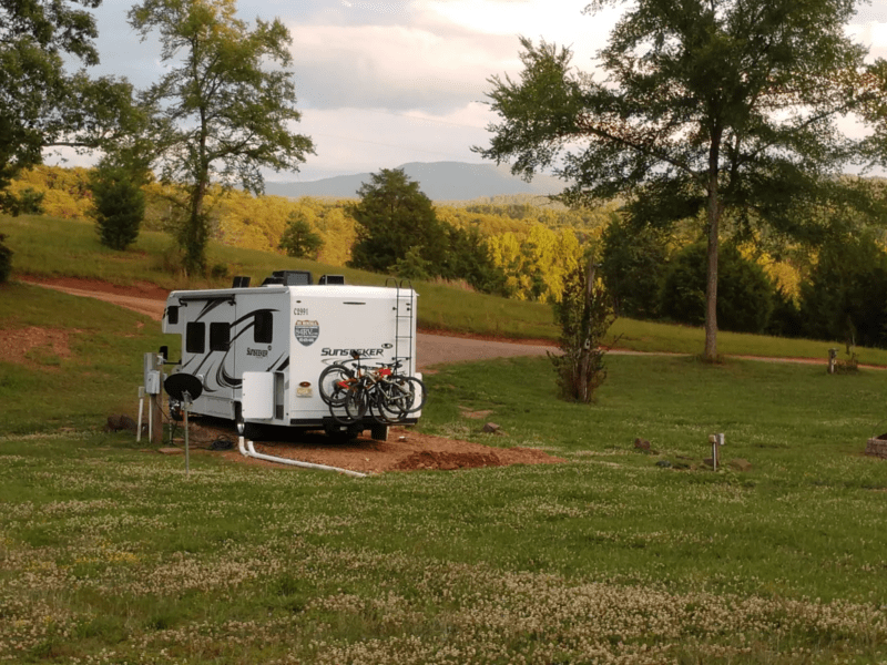 RV parked in a grassy area with at a Hipcamp campsite