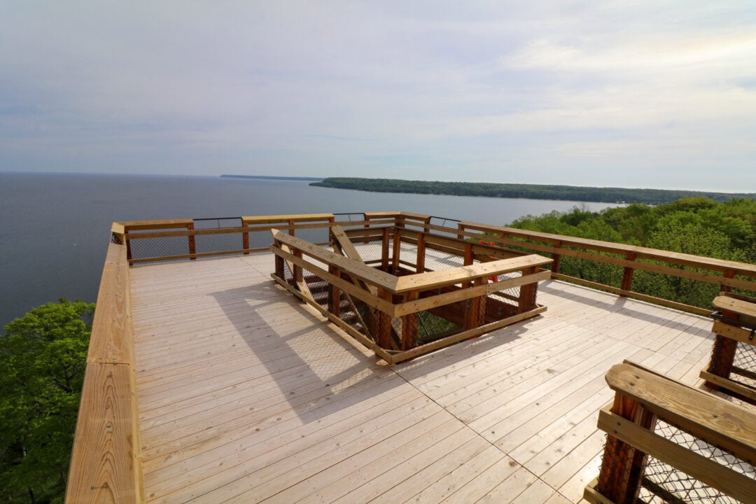 a wooden walkway overlooks a body of water