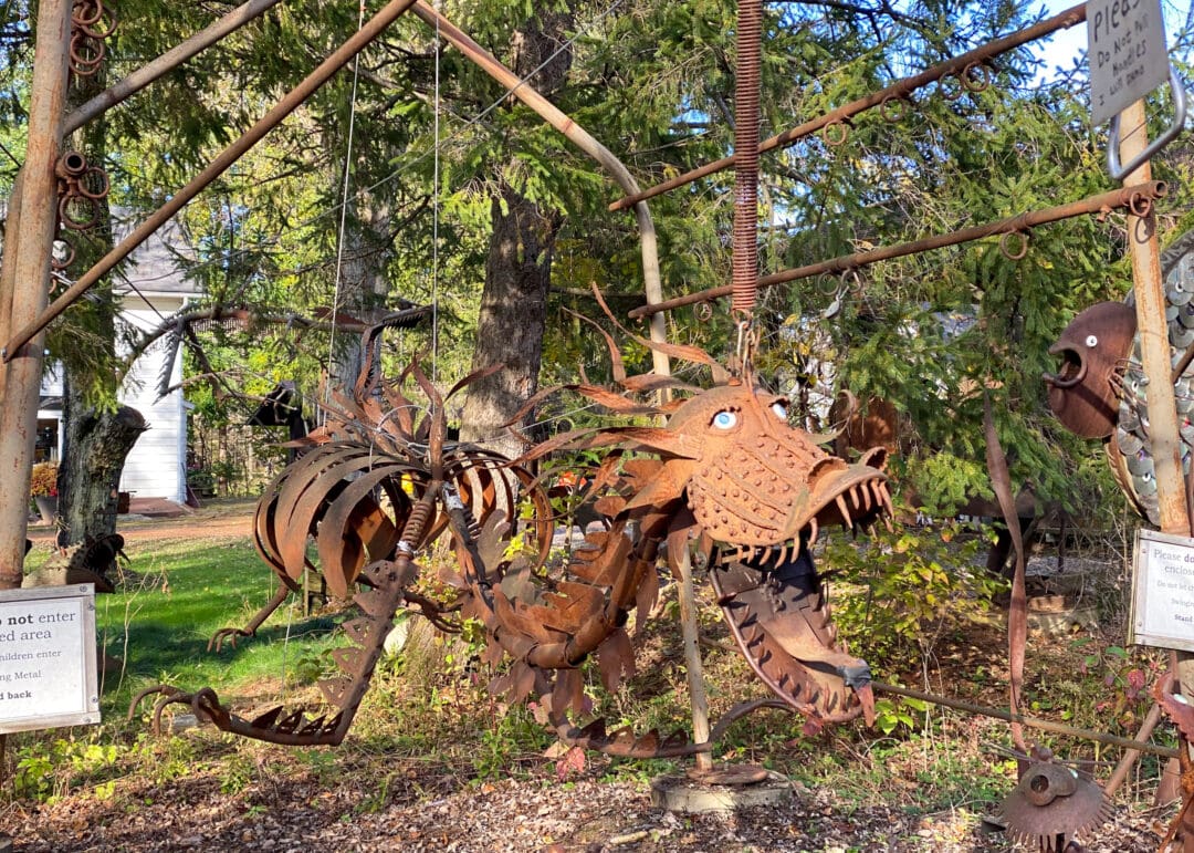 a creature made of scap metal sits outside